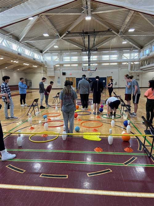 Students being guided through a course during a cooperative game 